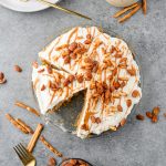 Overhead view of no bake peanut butter pretzel pie topped with peanut butter drizzle, honey-roasted peanuts, and gluten free pretzels