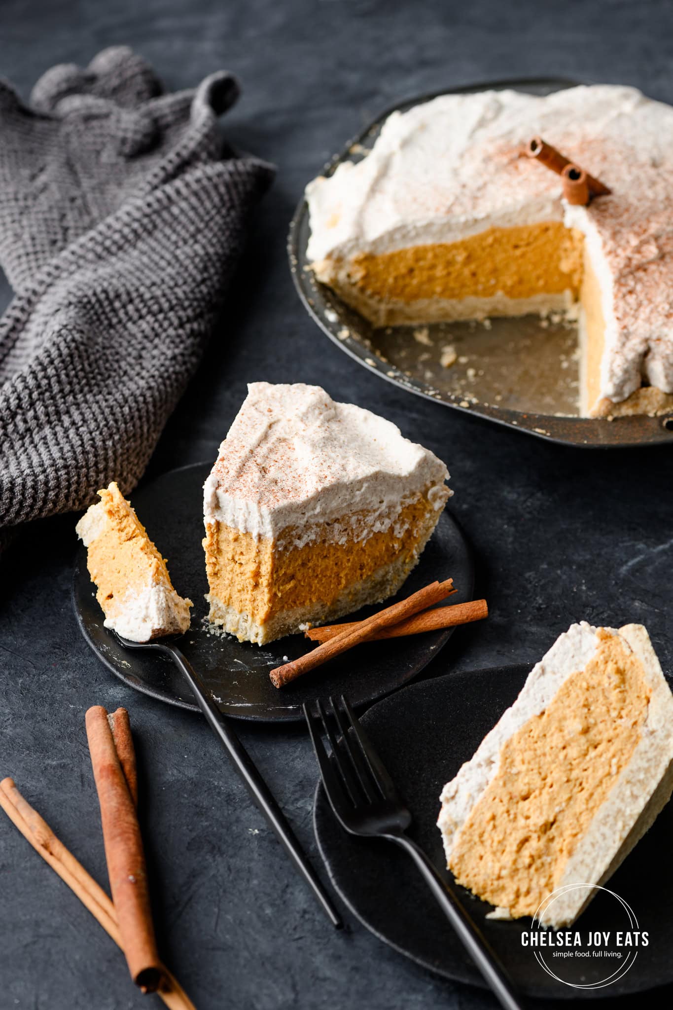 Gluten free no bake pumpkin pie topped with a layer of whipped cream on a plate