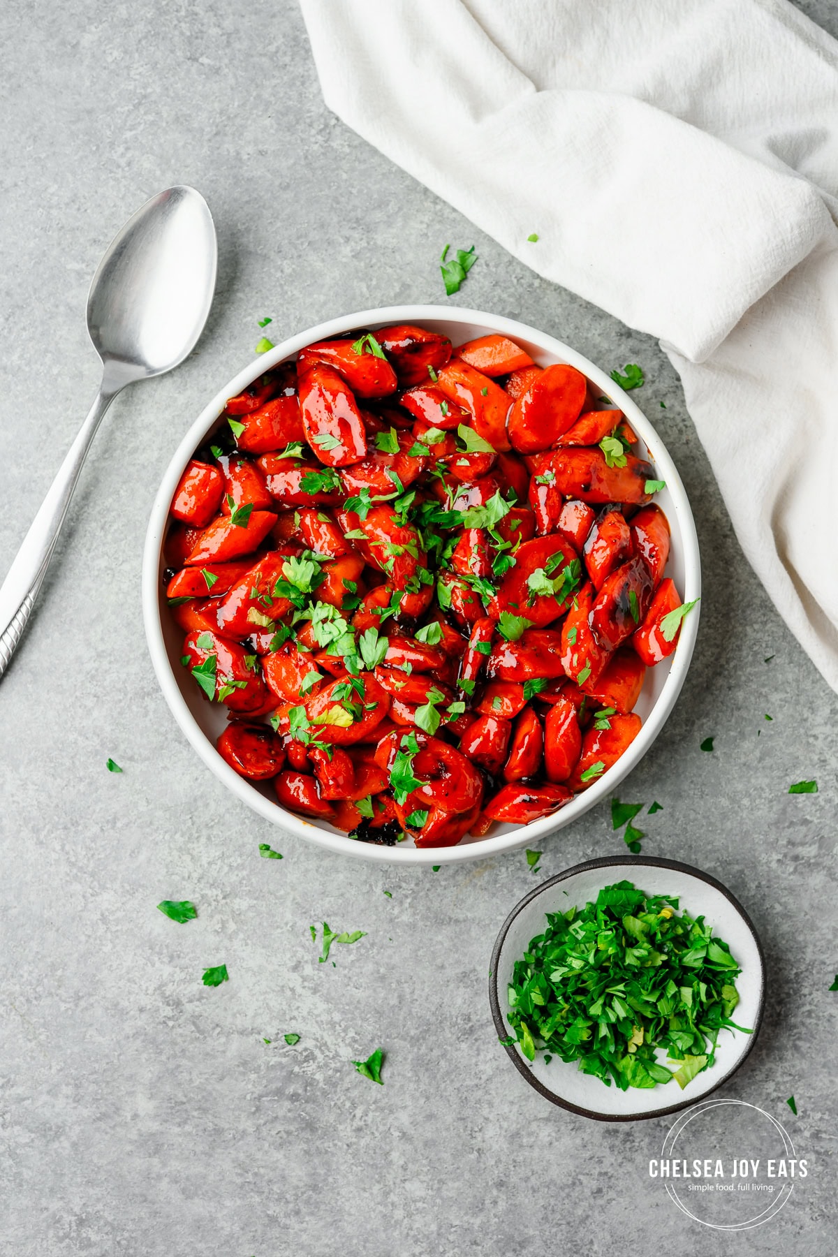 Bird's eye view of hot honey glazed carrots and garnished with chopped parsley