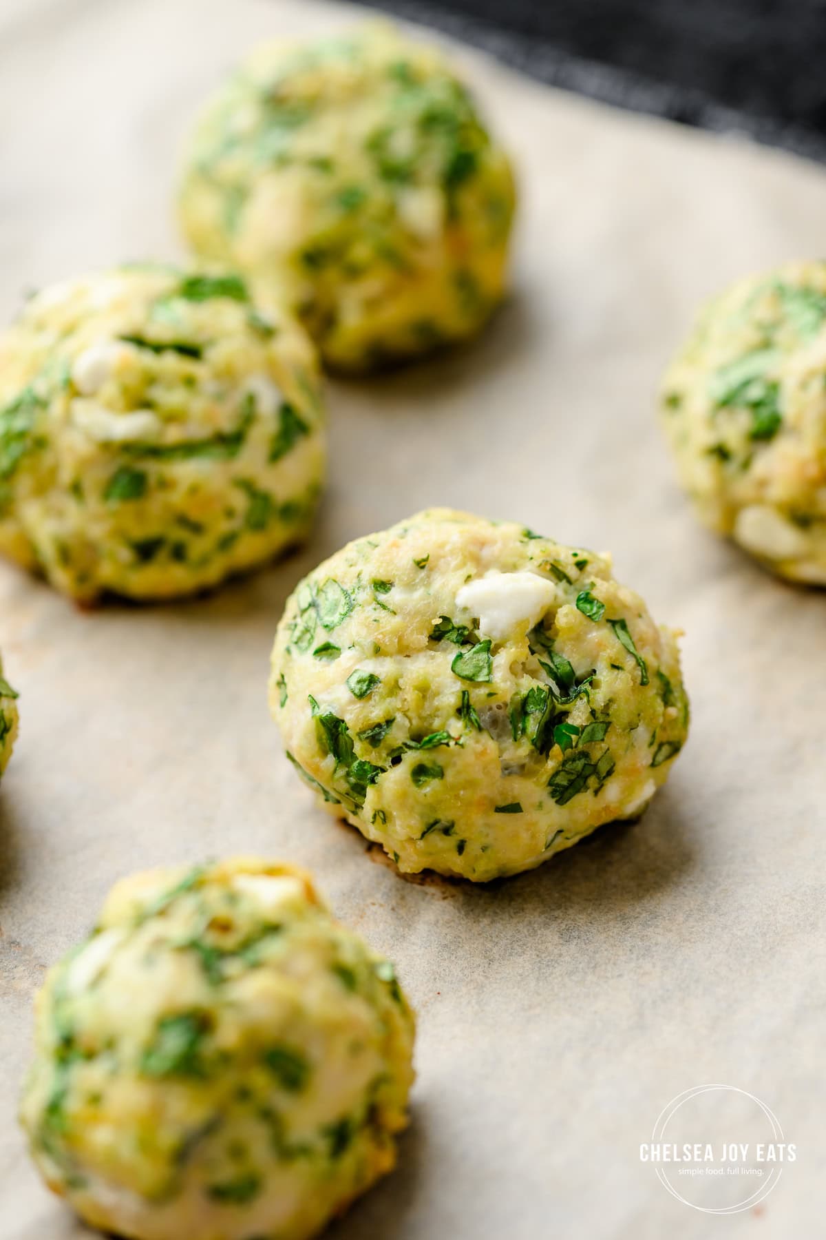 Closeup of a baked gluten free chicken meatball on a baking sheet