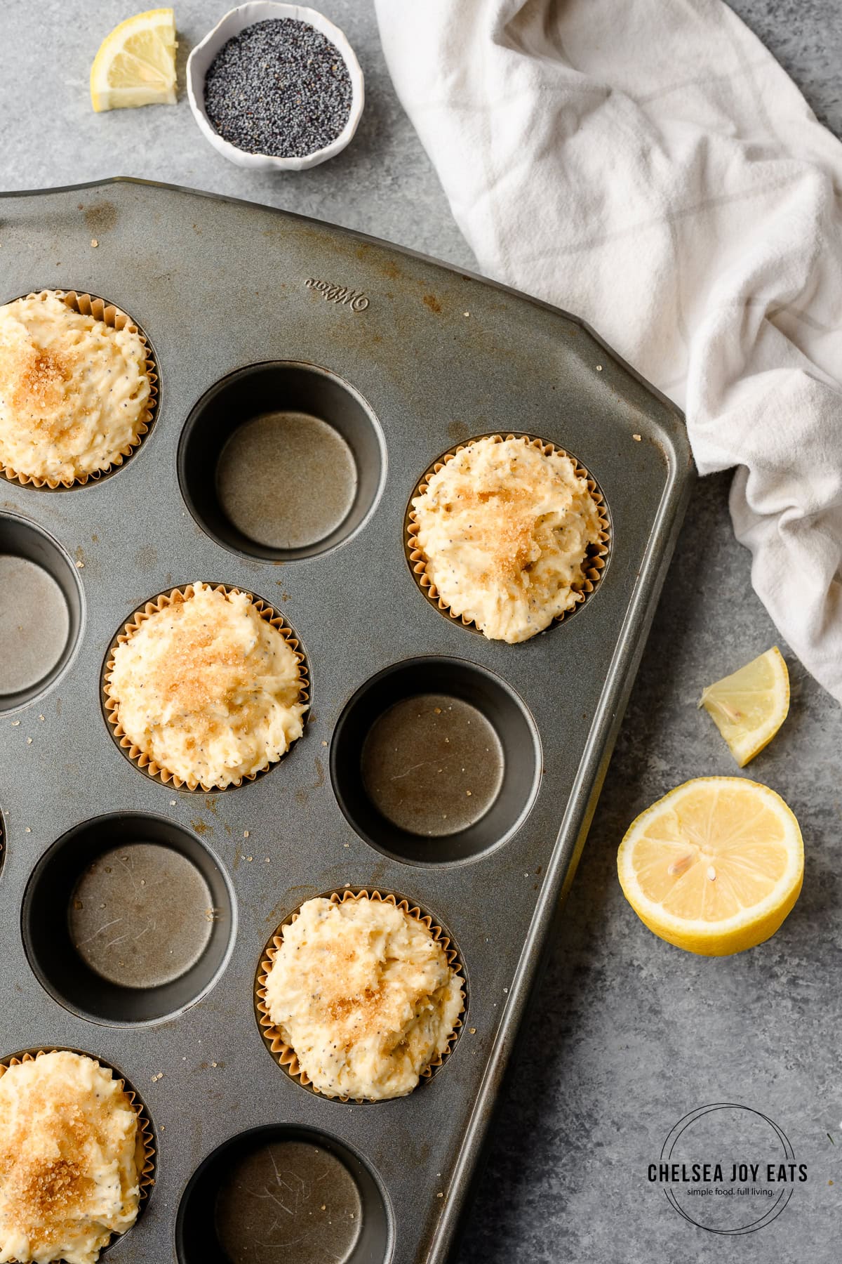 Unbaked muffin batter in paper liners within a muffin tray