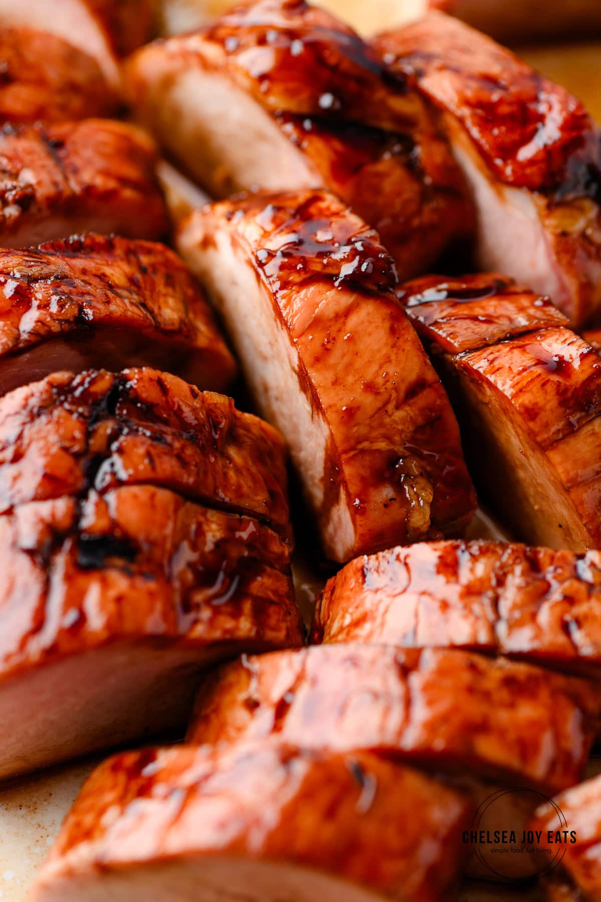 Closeup of sliced balsamic glazed smoked pork tenderloin