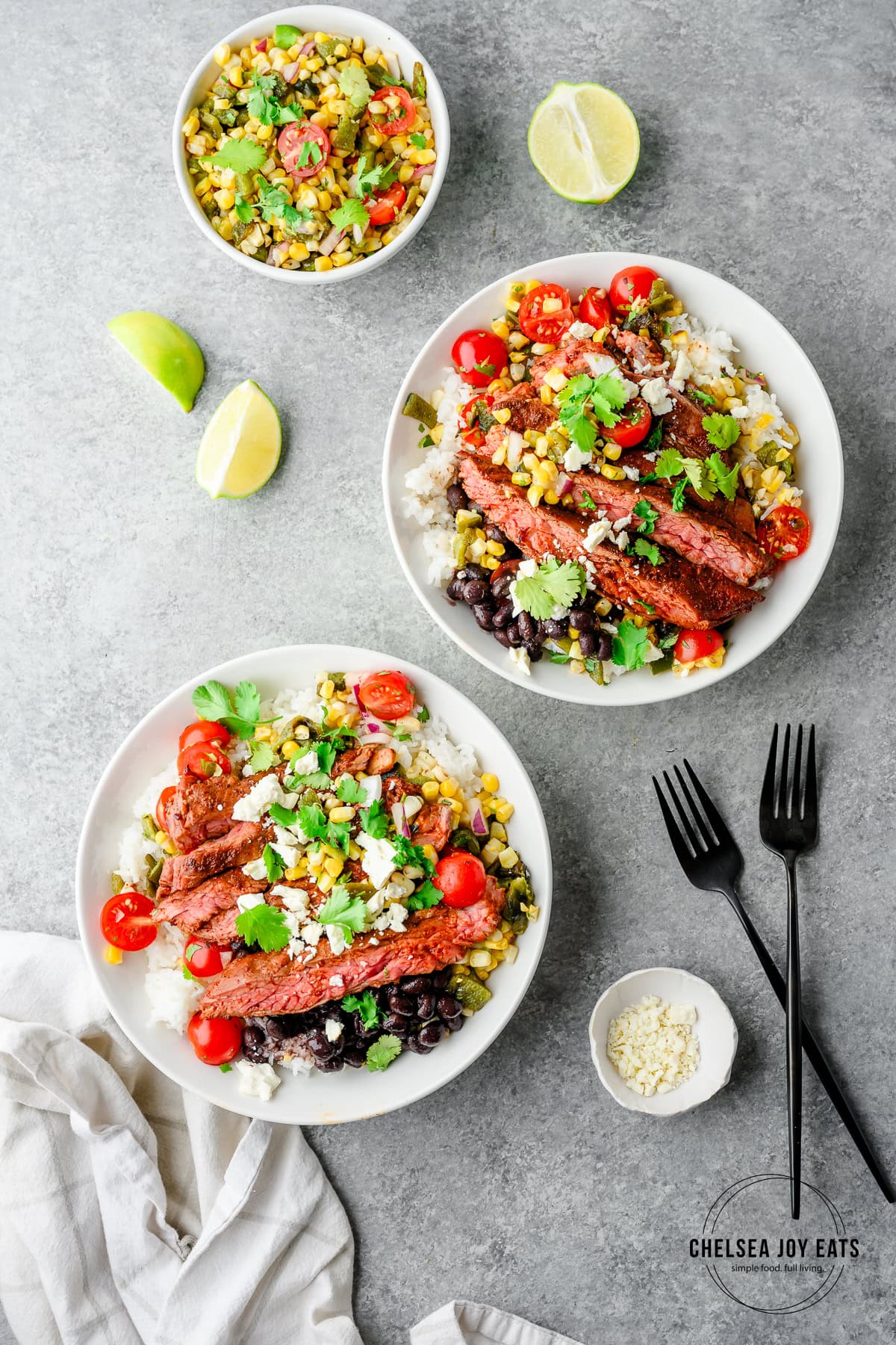 Overhead view of ancho skirt steak bowls with poblano corn salsa, with a bowl of extra salsa beside