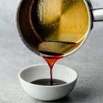 Teriyaki sauce being poured from a saucepan into a bowl
