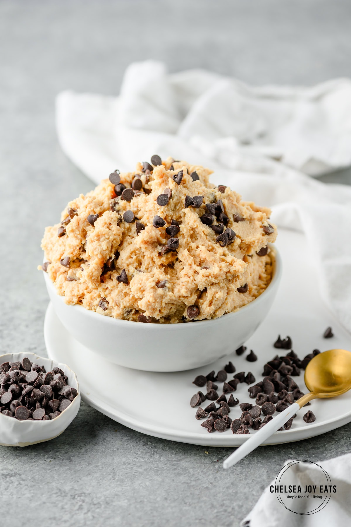 Bowl filled with high protein cottage cheese cookie dough made without almond flour, with mini chocolate chips scattered around