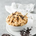 Bowl of high protein cottage cheese cookie dough made without almond flour, with mini chocolate chips scattered around