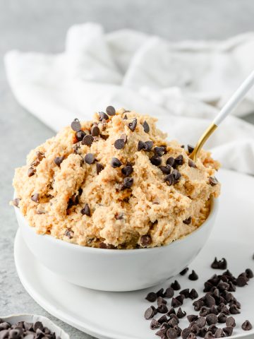 Bowl of high protein cottage cheese cookie dough made without almond flour, with mini chocolate chips scattered around