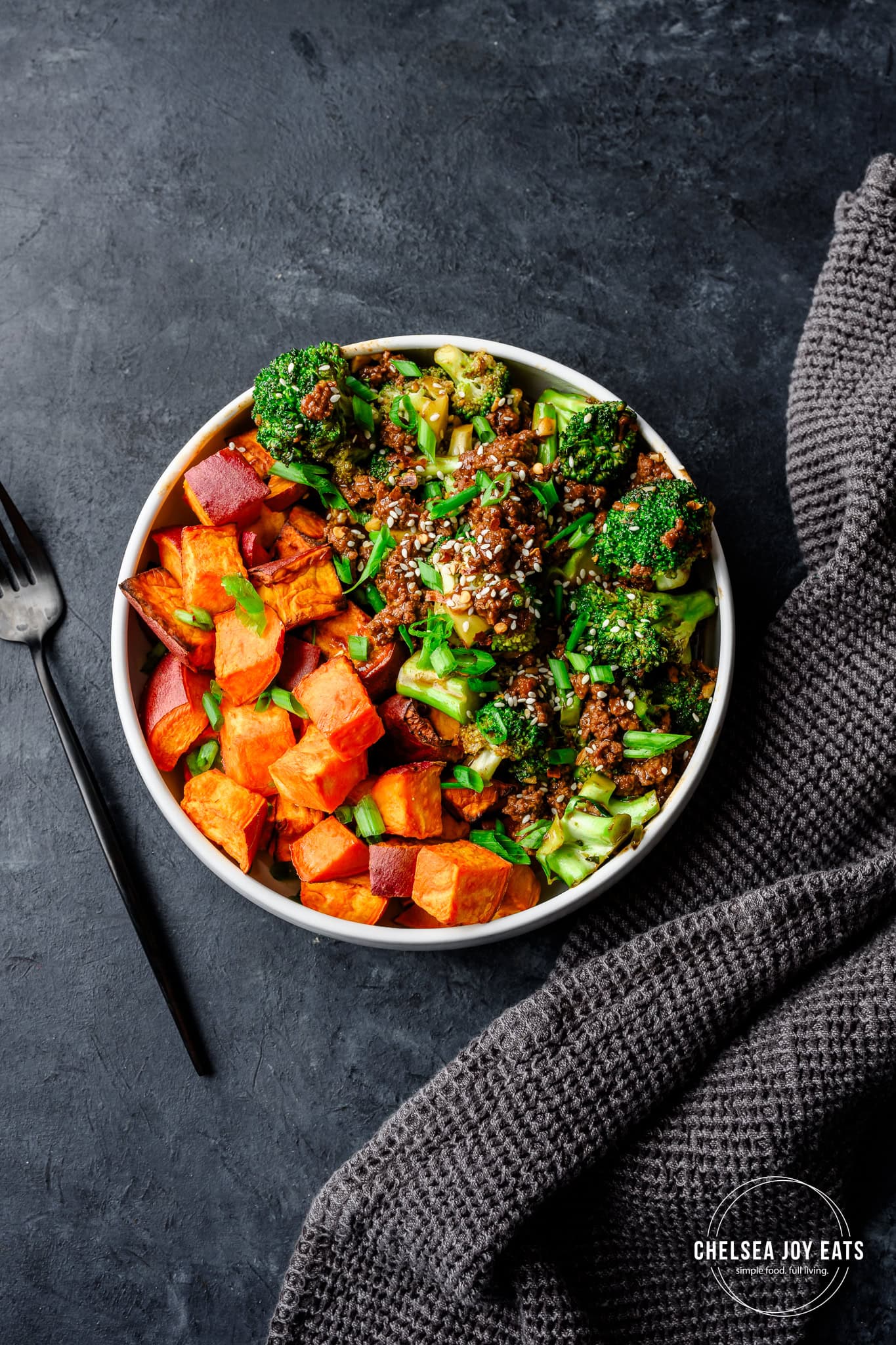 Overhead view of broccoli and ground beef stir fry served with roasted sweet potatoes