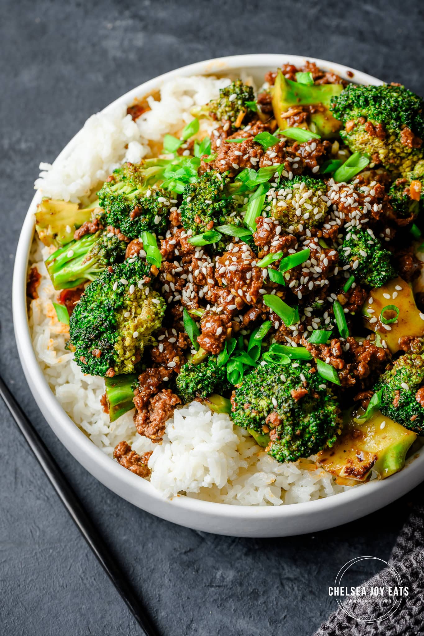 Closeup of ground beef and broccoli stir fry served over rice