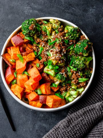 Bowl of ground beef and broccoli stir fry served with roasted sweet potatoes