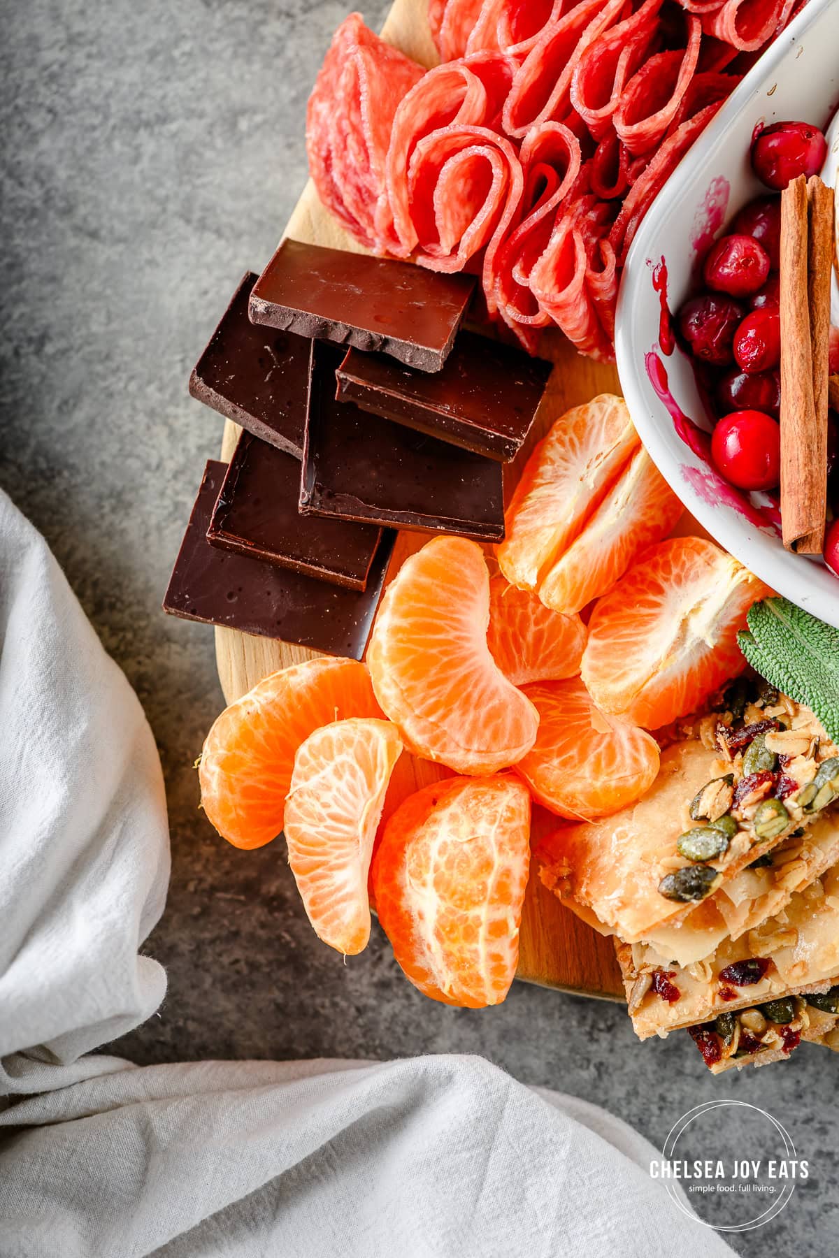Closeup of mandarin wedges and dark chocolate on a fall charcuterie board