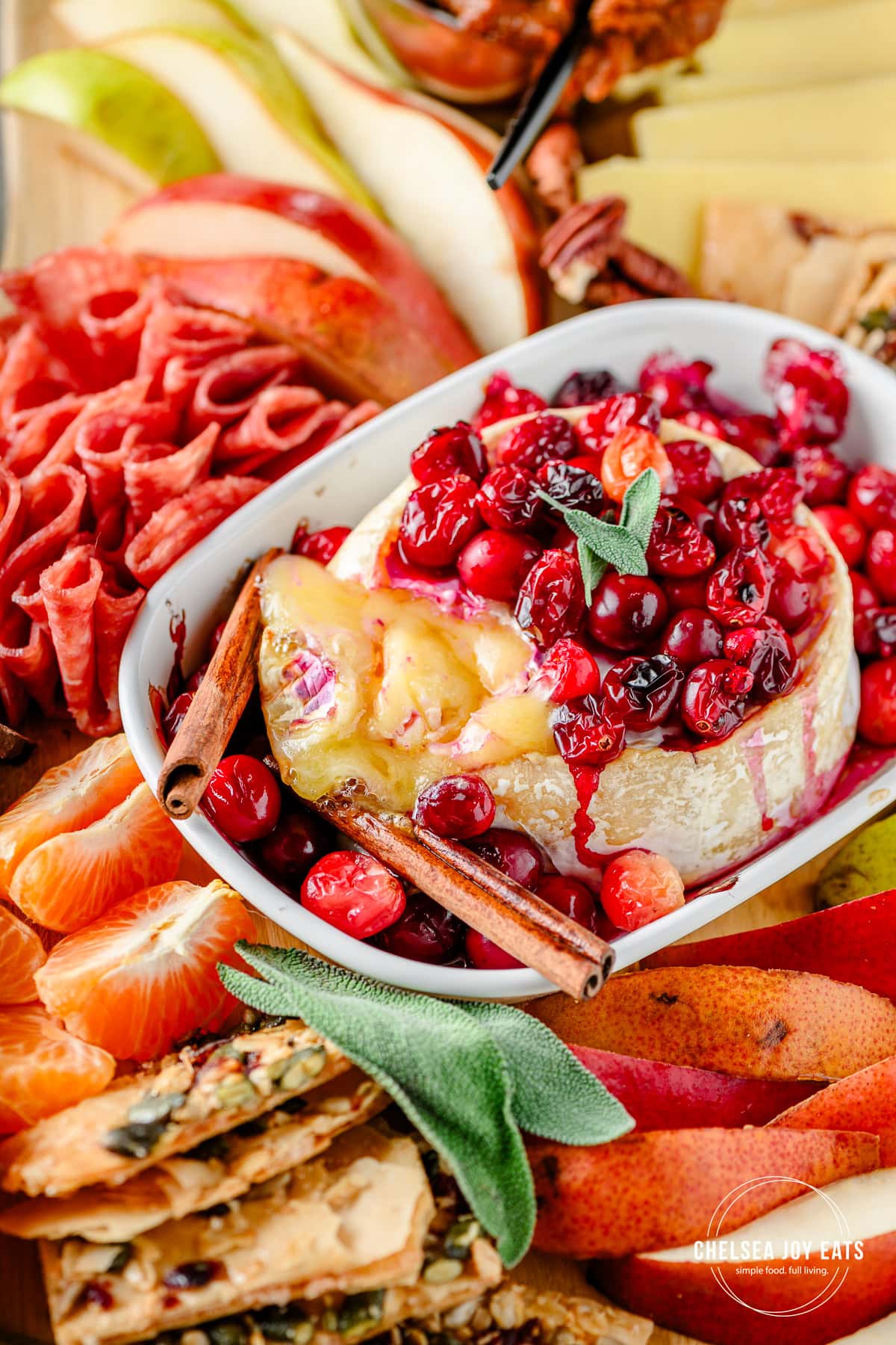 Closeup of cranberry baked brie on a fall charcuterie board