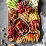 Fall-themed charcuterie board with seasonal produce