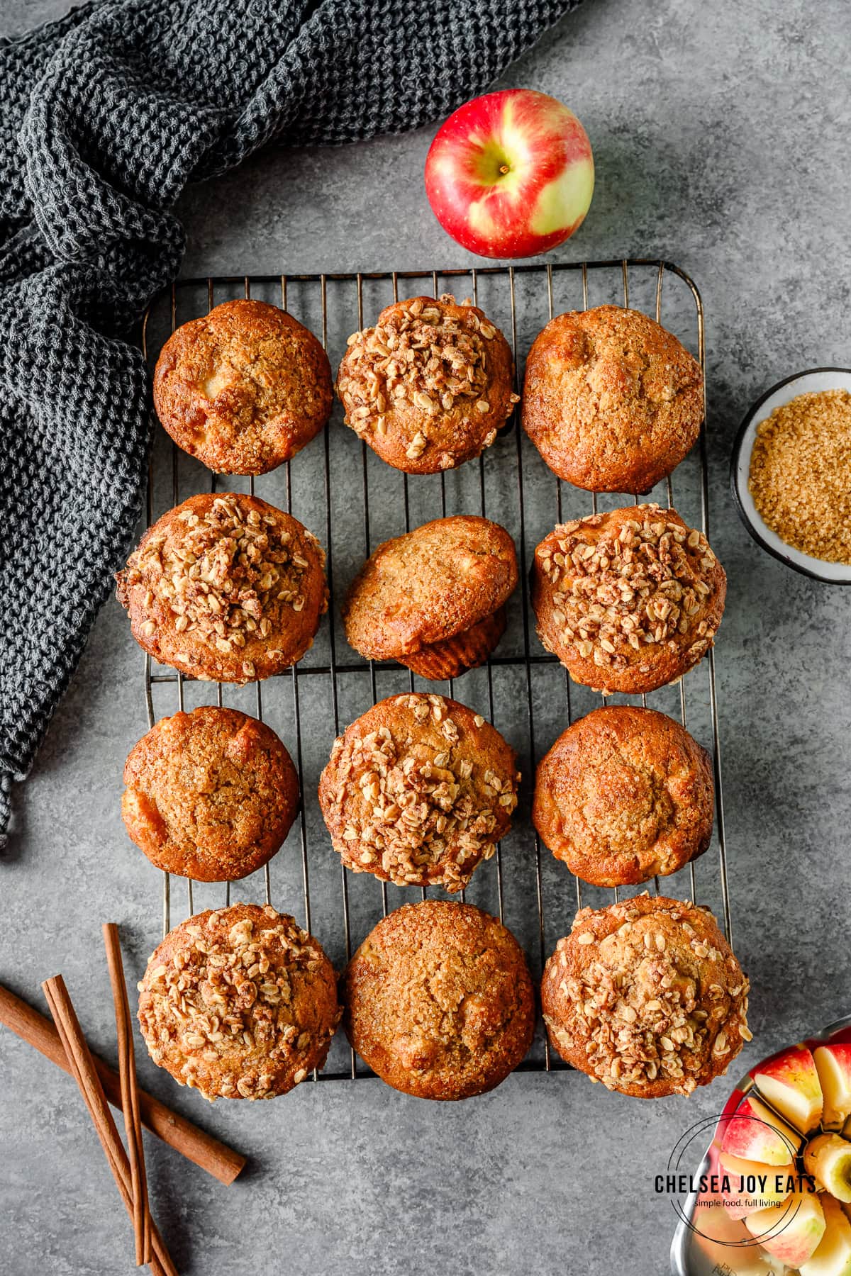 Overhead view of a batch of gluten free apple muffins lined up on a wire rack