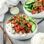 Bowl of rice with chicken teriyaki and quick-pickled cucumbers