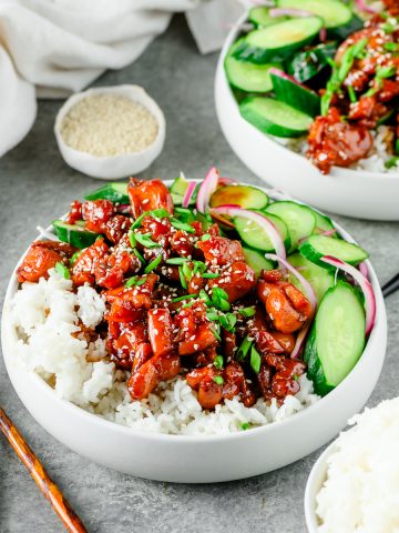 Bowl of rice with chicken teriyaki and quick-pickled cucumbers