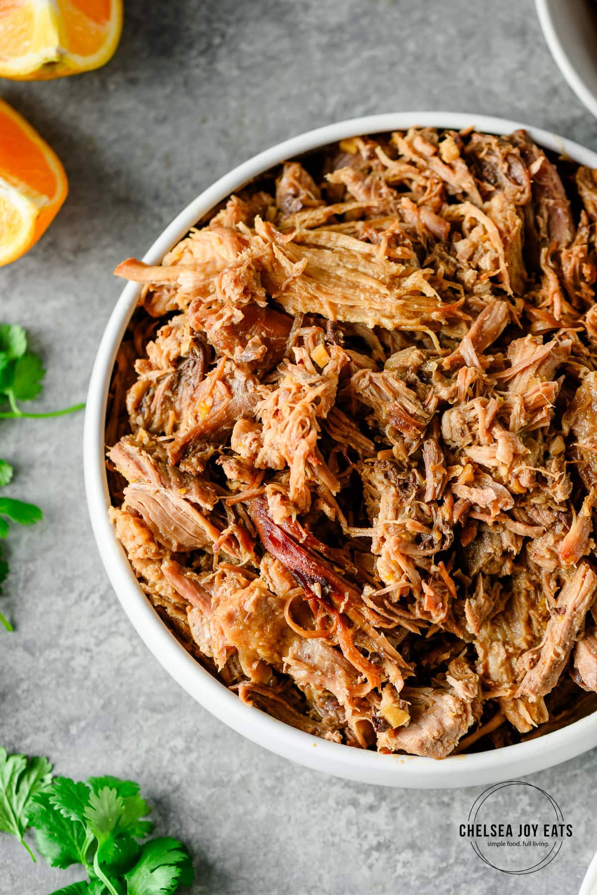 Closeup of a bowl of orange-glazed pulled pork