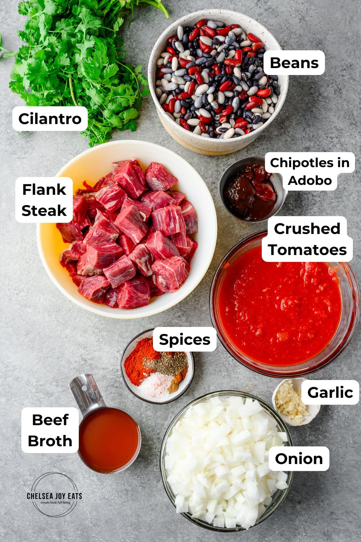 Ingredients for flank steak chili with adobos with text labels for each ingredient
