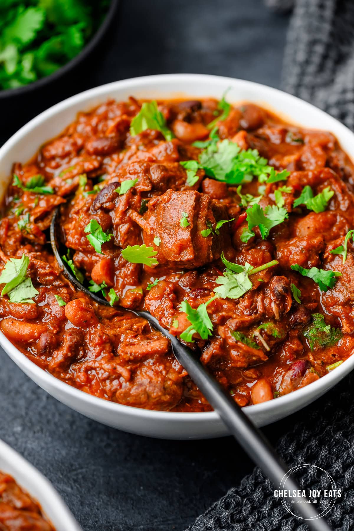 Closeup of a bowl of flank steak chili topped with minced fresh cilantro
