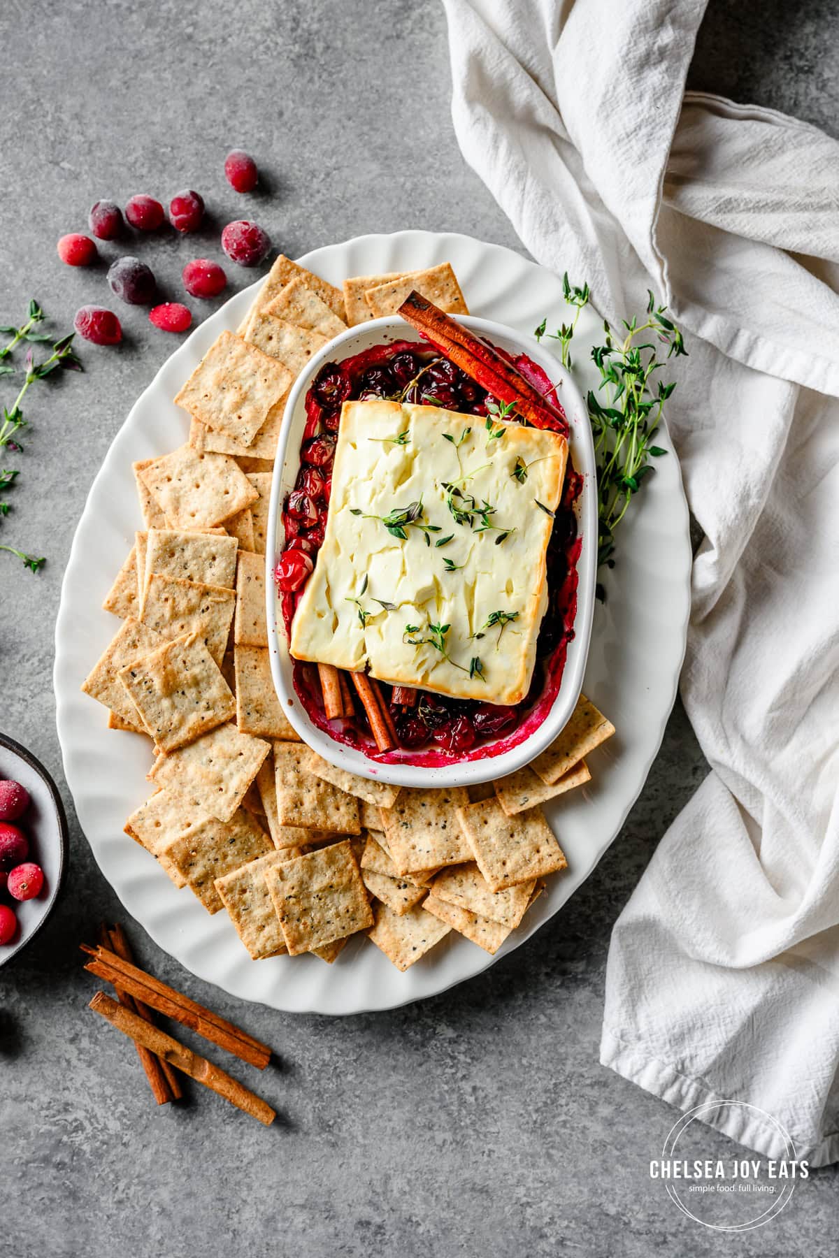 Overhead view of baked feta cheese with cranberries served with gluten free crackers