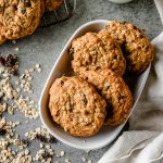 Overhead view of gluten free oatmeal raisin cookies layered in a serving dish