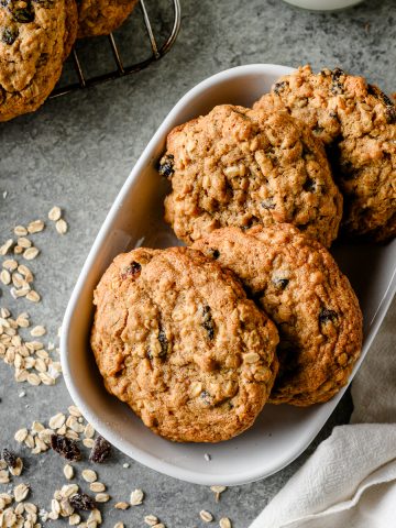 Overhead view of gluten free oatmeal raisin cookies layered in a serving dish
