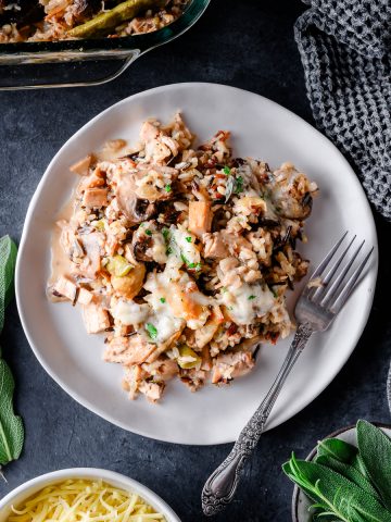 Serving of Turkey Wild Rice Casserole made with leftover turkey, with fresh herbs as garnish