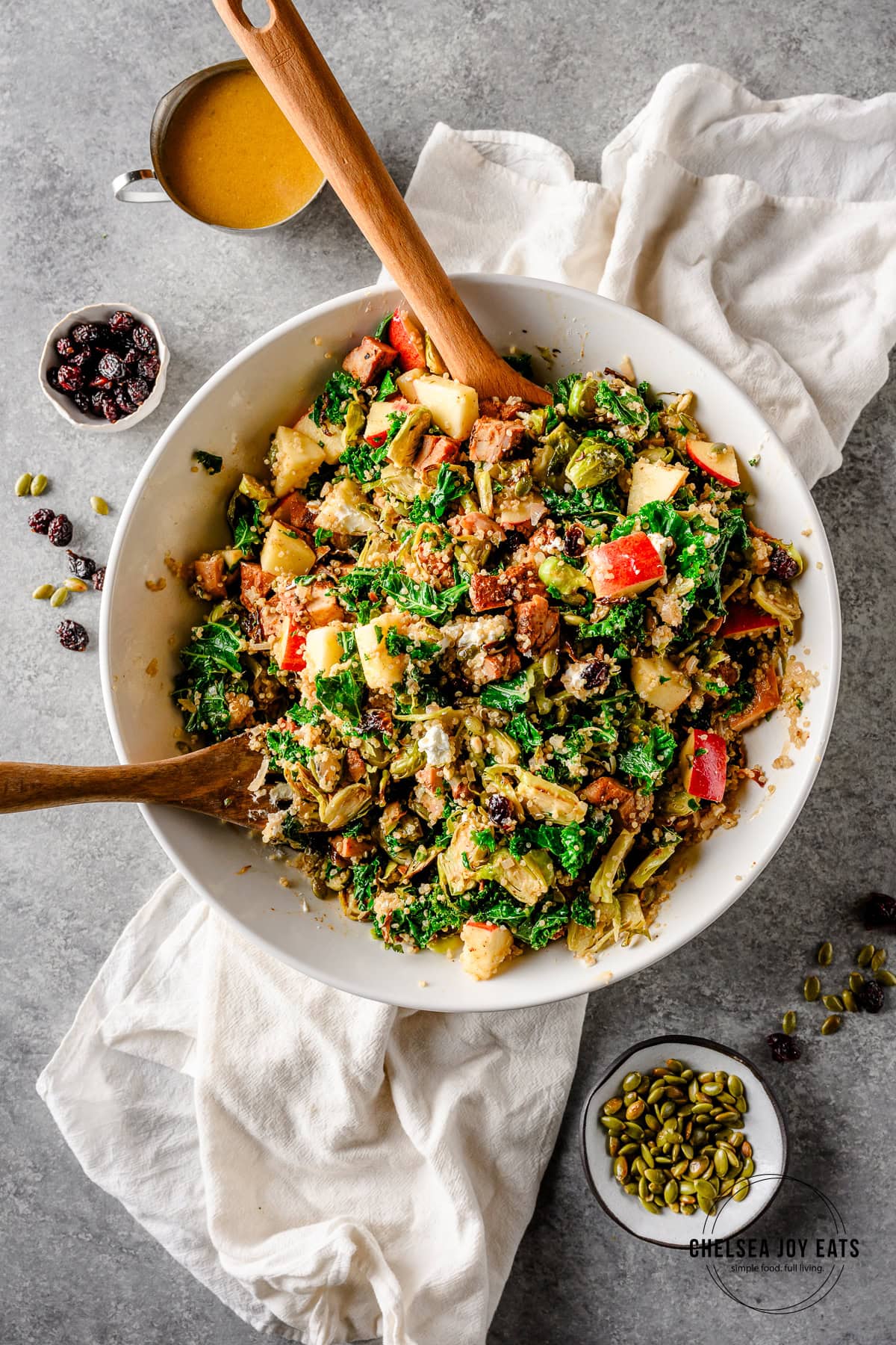 Overhead view of a kale, quinoa, and brussels sprouts salad tossed with apple dressing