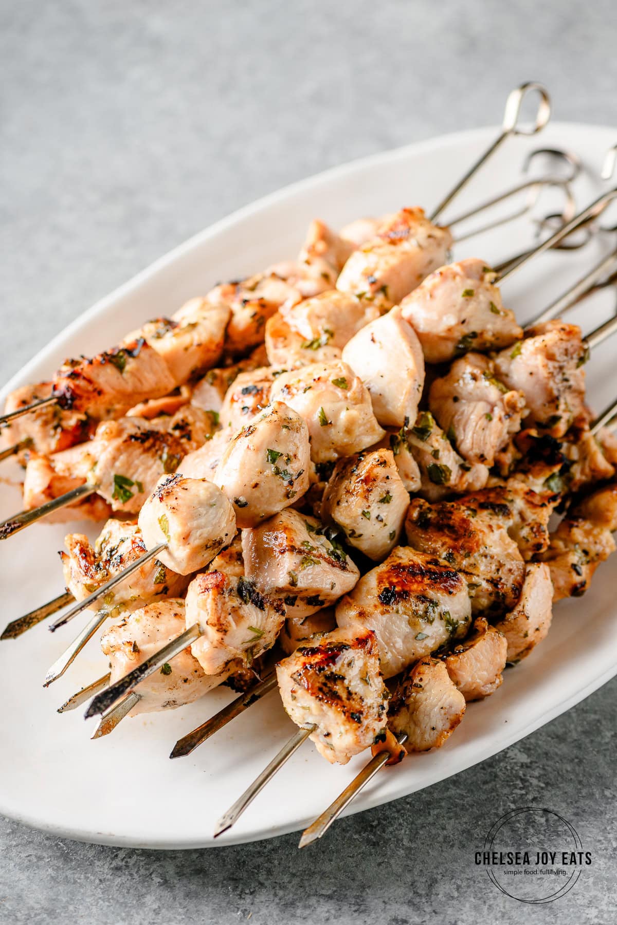 Chicken souvlaki skewers piles on a platter