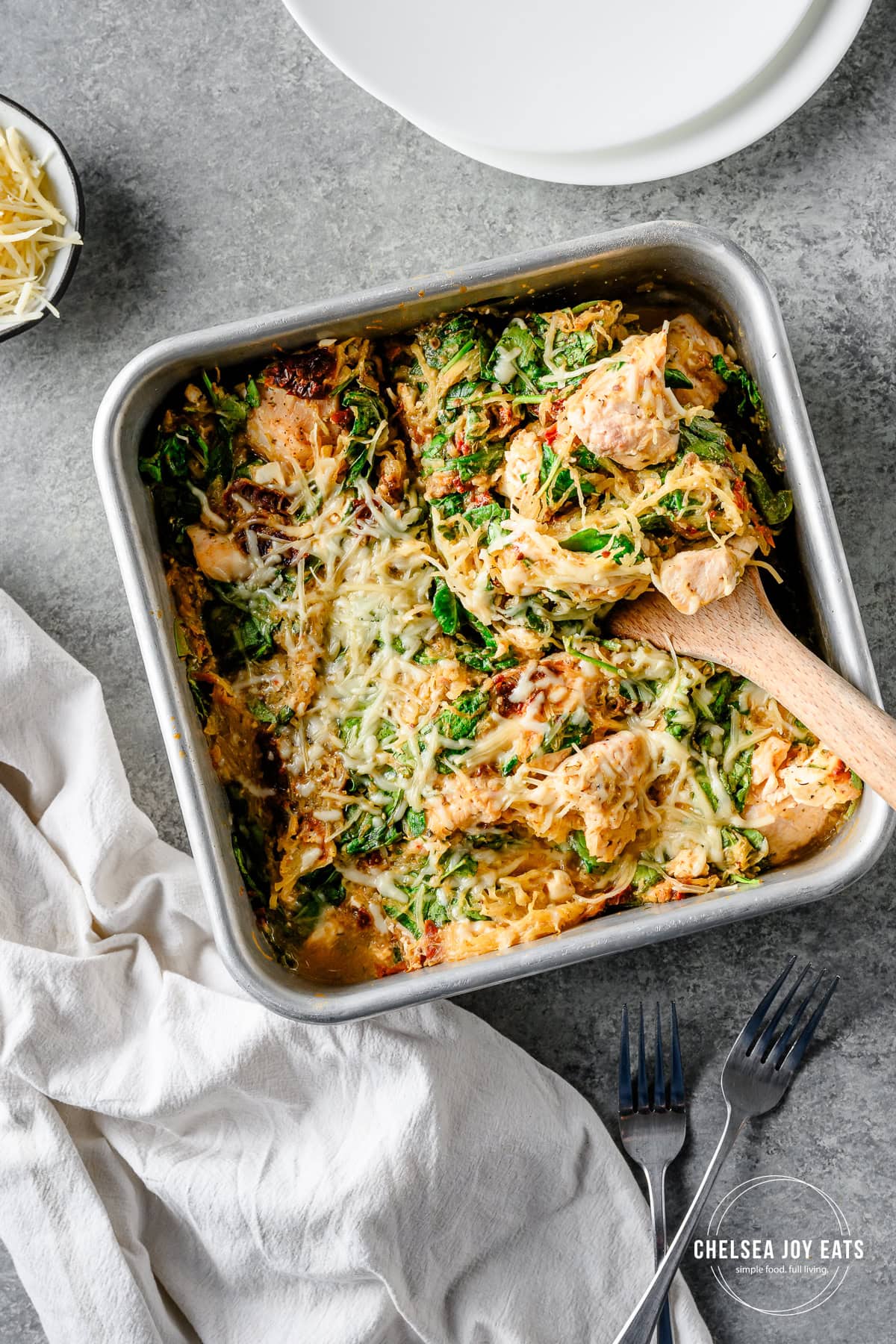 Overhead view of a spatula taking a serving out of a feta chicken spaghetti squash casserole to serve