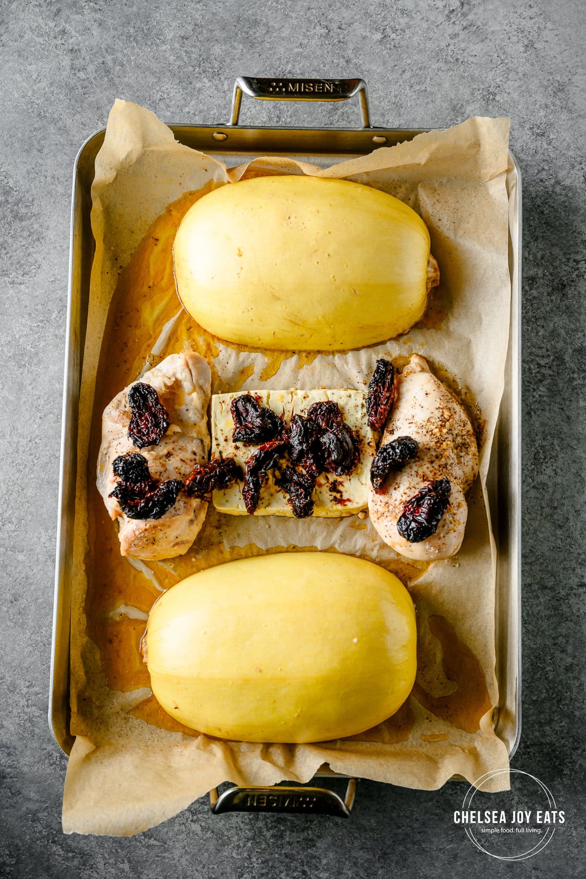 Overhead view of roasted spaghetti squash, chicken, feta cheese, and sun-dried tomatoes