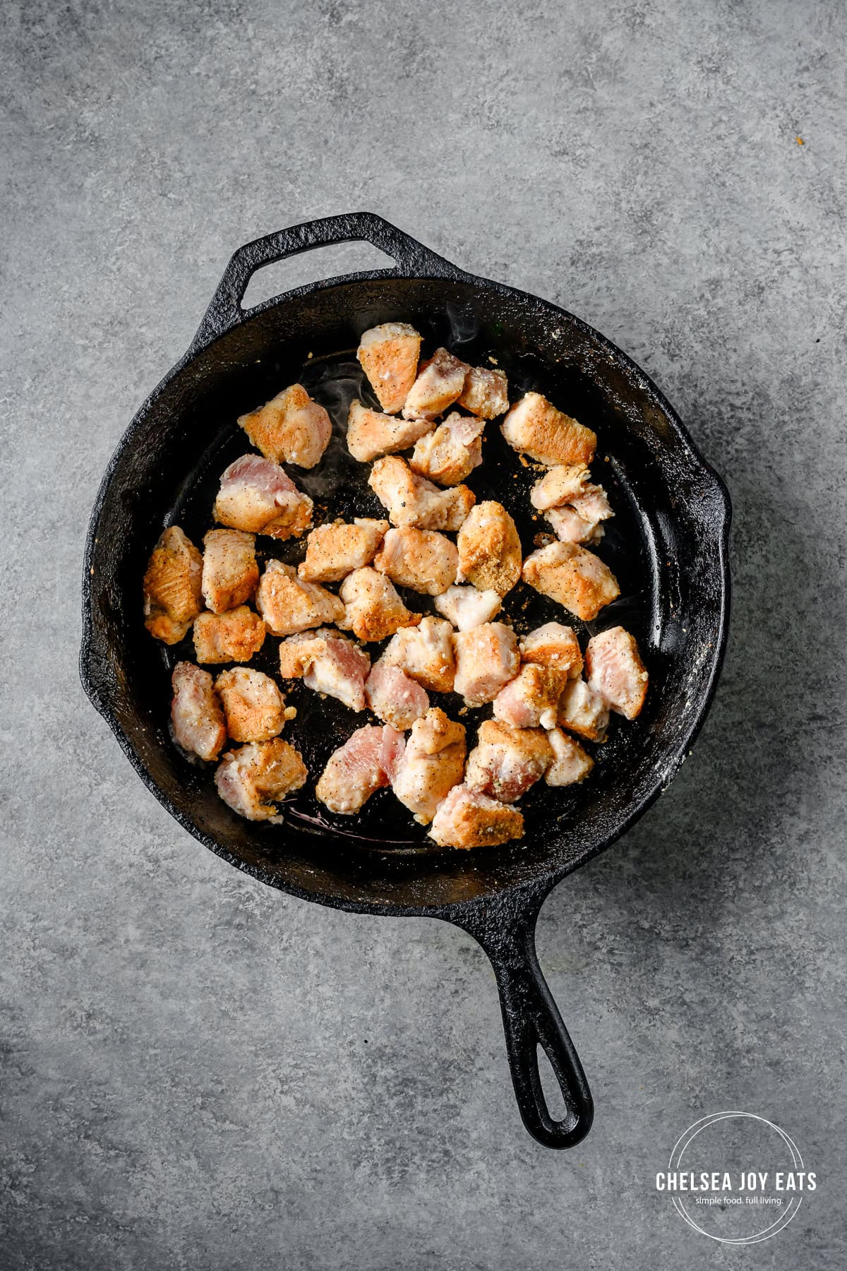 Browned chicken pieces in a skillet