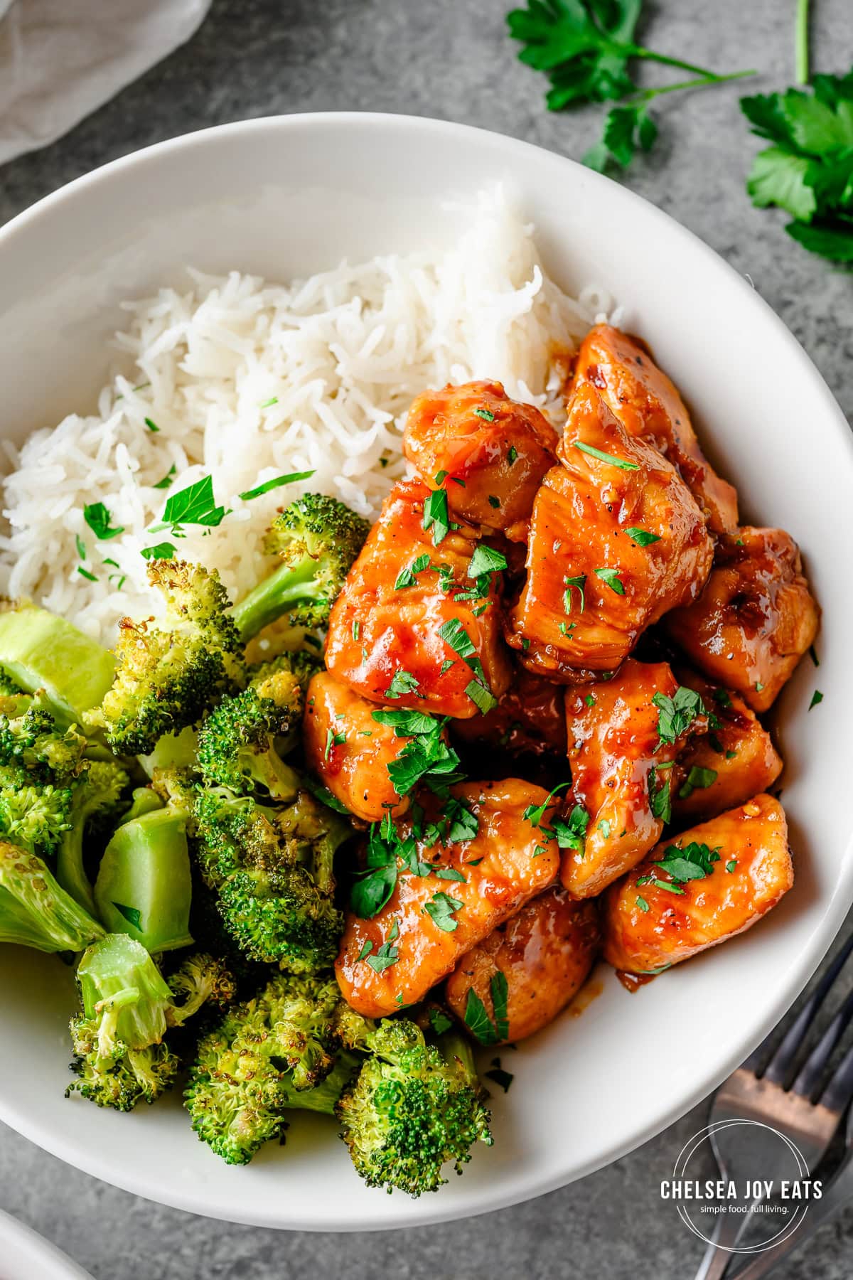 Closeup of honey garlic chicken bowls with roasted broccoli and rice