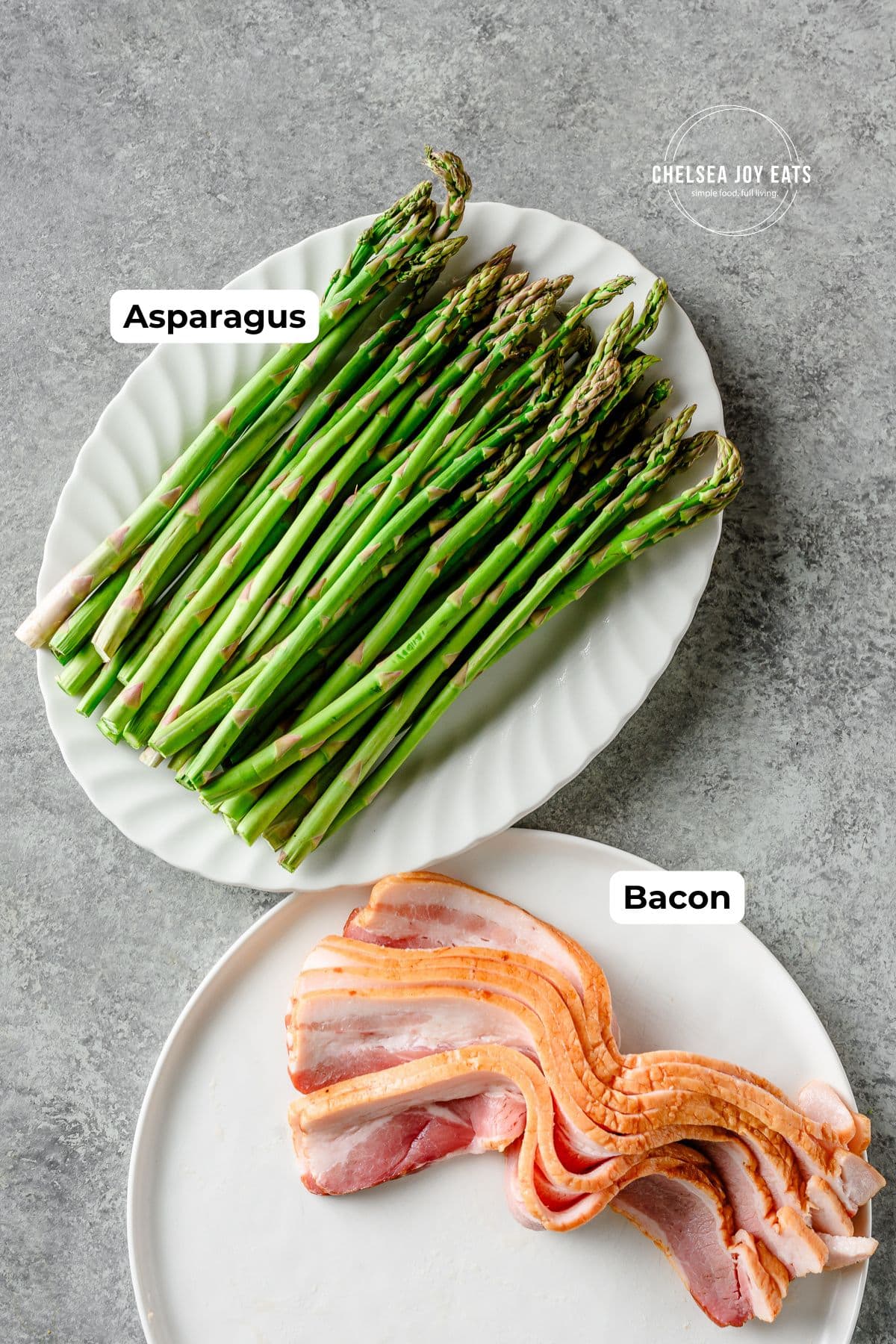 Fresh asparagus on a white platter and uncooked bacon on a white plate next to it, with text labels for each.
