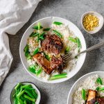 Bowl with rice and ginger scallion short ribs, garnished with ginger and scallions.