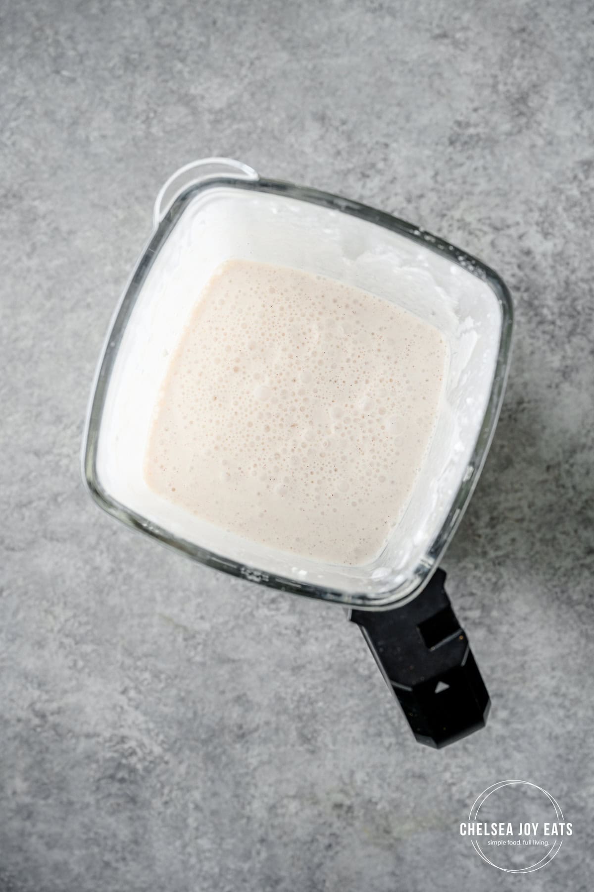 Blended cottage cheese and water in a blender pitcher.