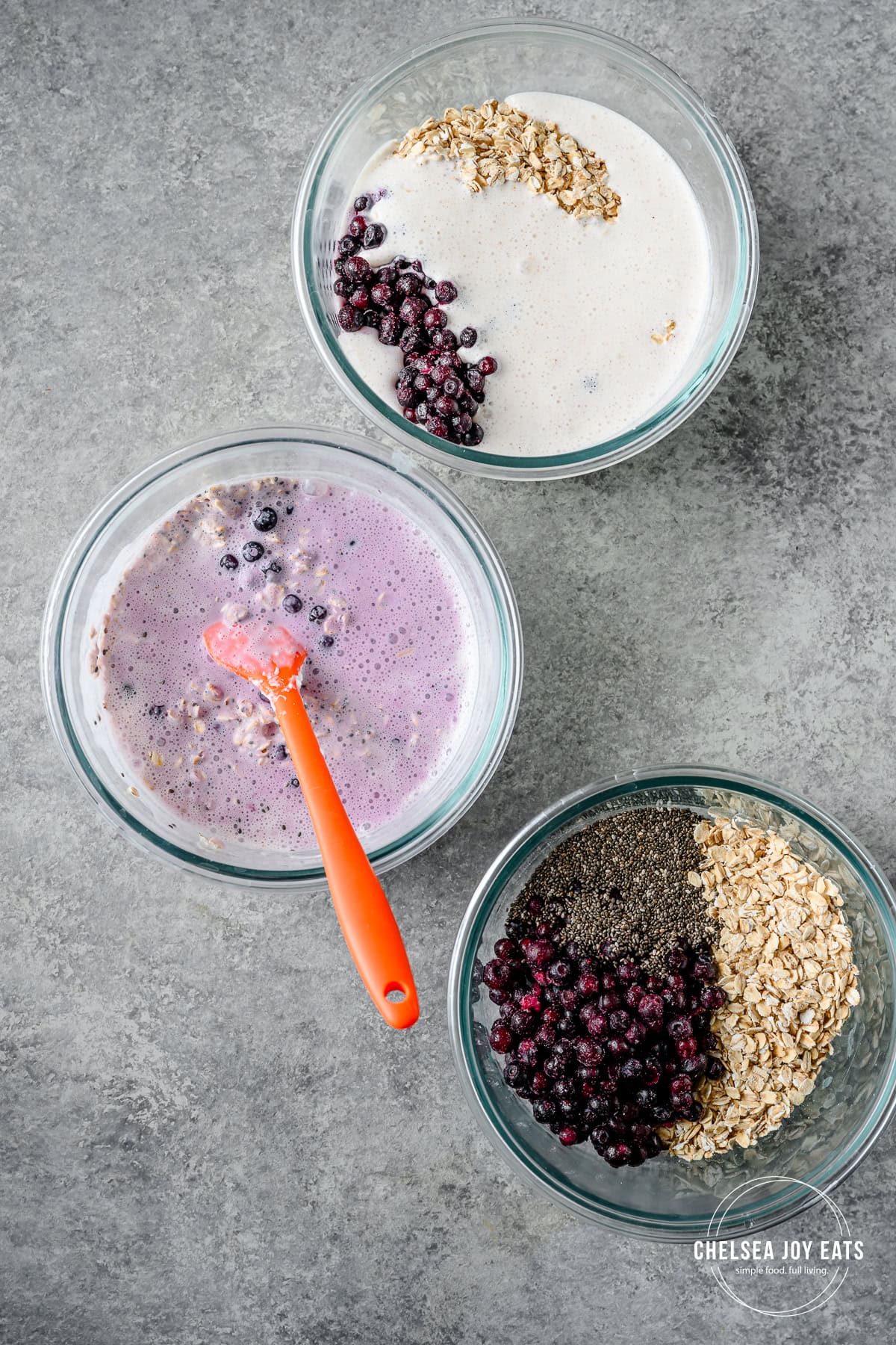 Bowls with oats, frozen blueberries, and blended cottage cheese and water. In one bowl the mixture has been stirred together.