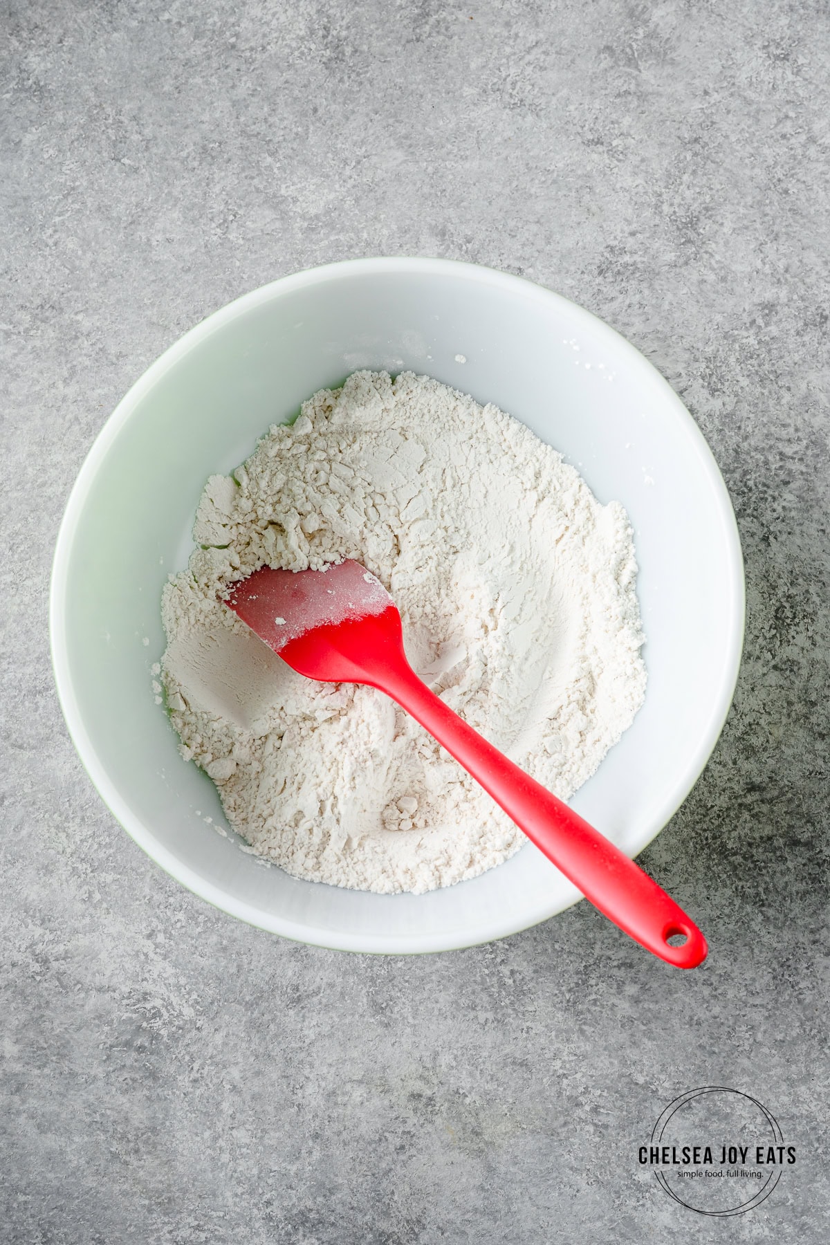 Dry ingredients for gluten free white chocolate macadamia nut cookies mixed in a bowl.