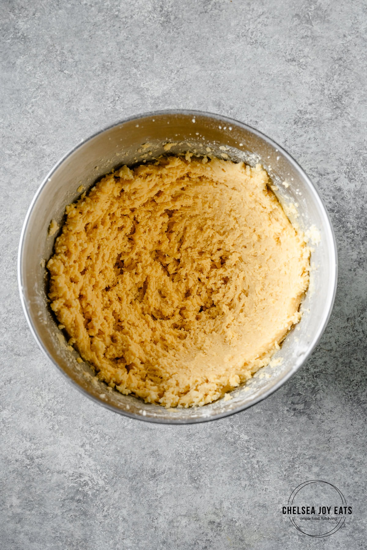 Gluten free cookie dough in the bowl of a stand mixer.
