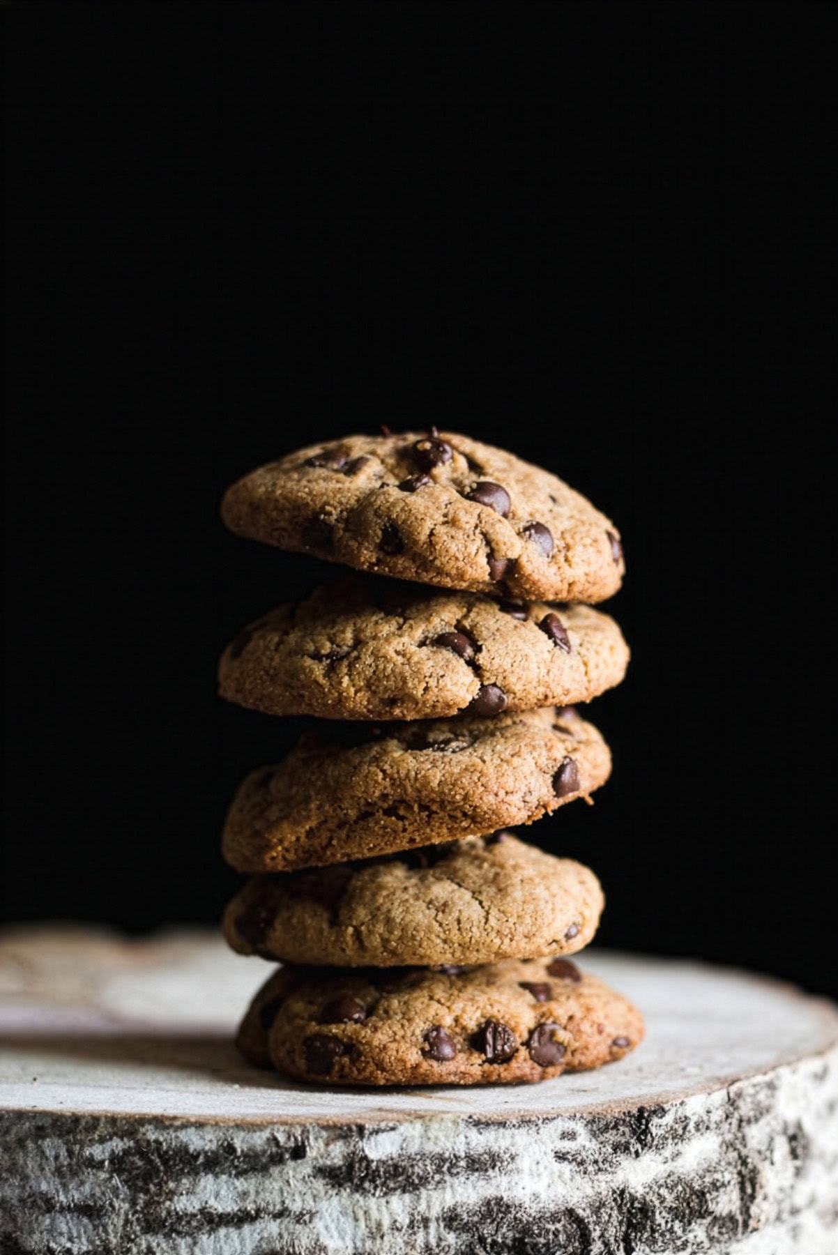 Gluten free tahini chocolate chip cookies stacked on top of each other.