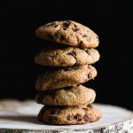 Gluten free tahini chocolate chip cookies stacked on top of each other.