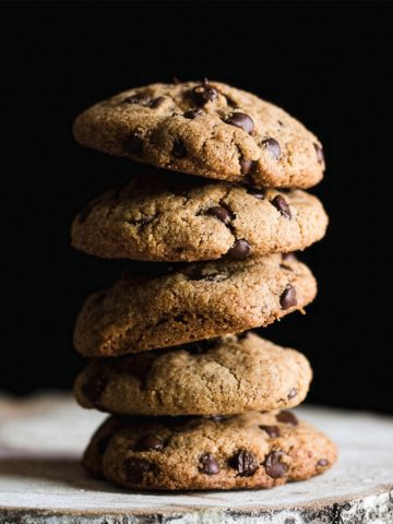 Gluten free tahini chocolate chip cookies stacked on top of each other.