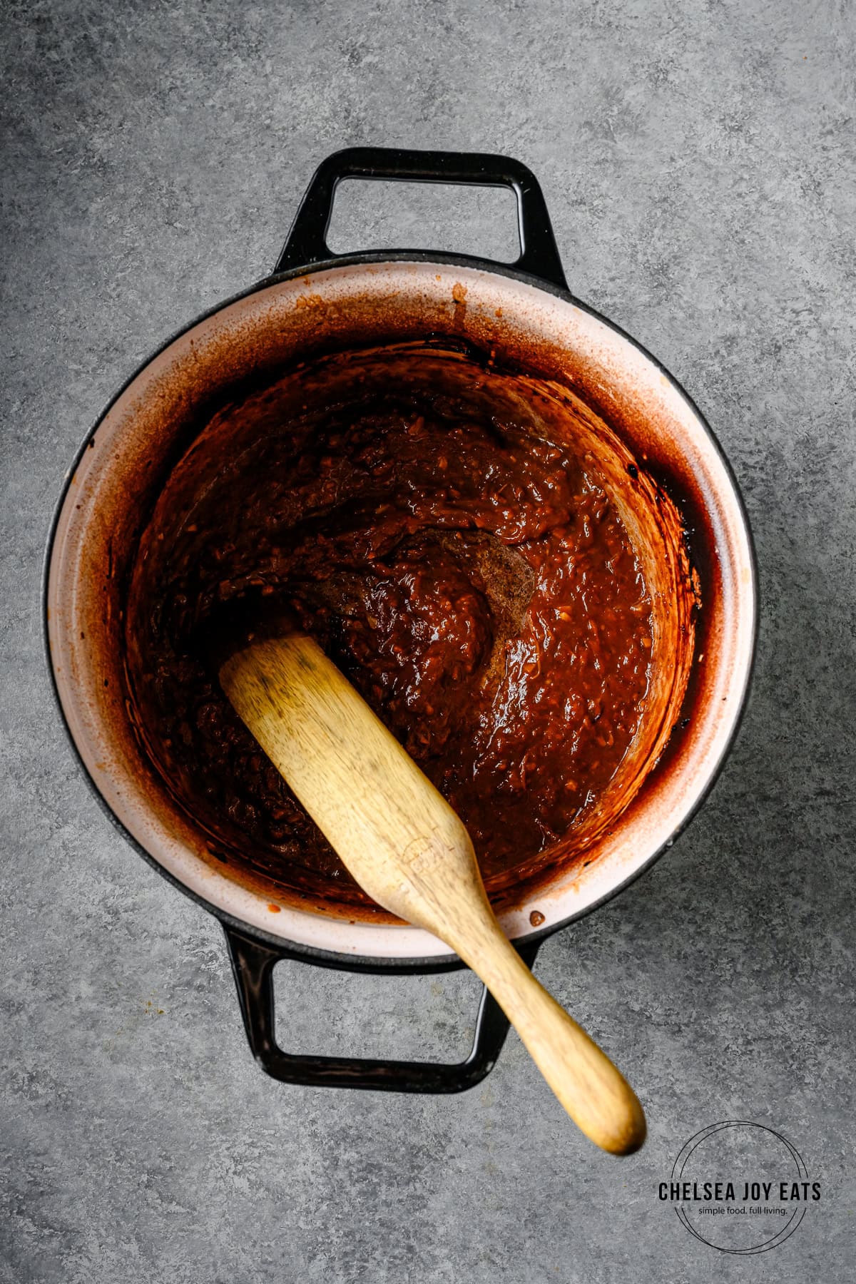 Miso orange braising liquid reduced to a glossy sauce in a Dutch oven.
