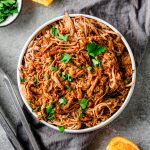 Serving bowl with Miso Orange Shredded Pork Tenderloin, topped with cilantro.