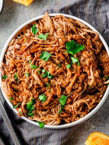 Serving bowl with Miso Orange Shredded Pork Tenderloin, topped with cilantro.