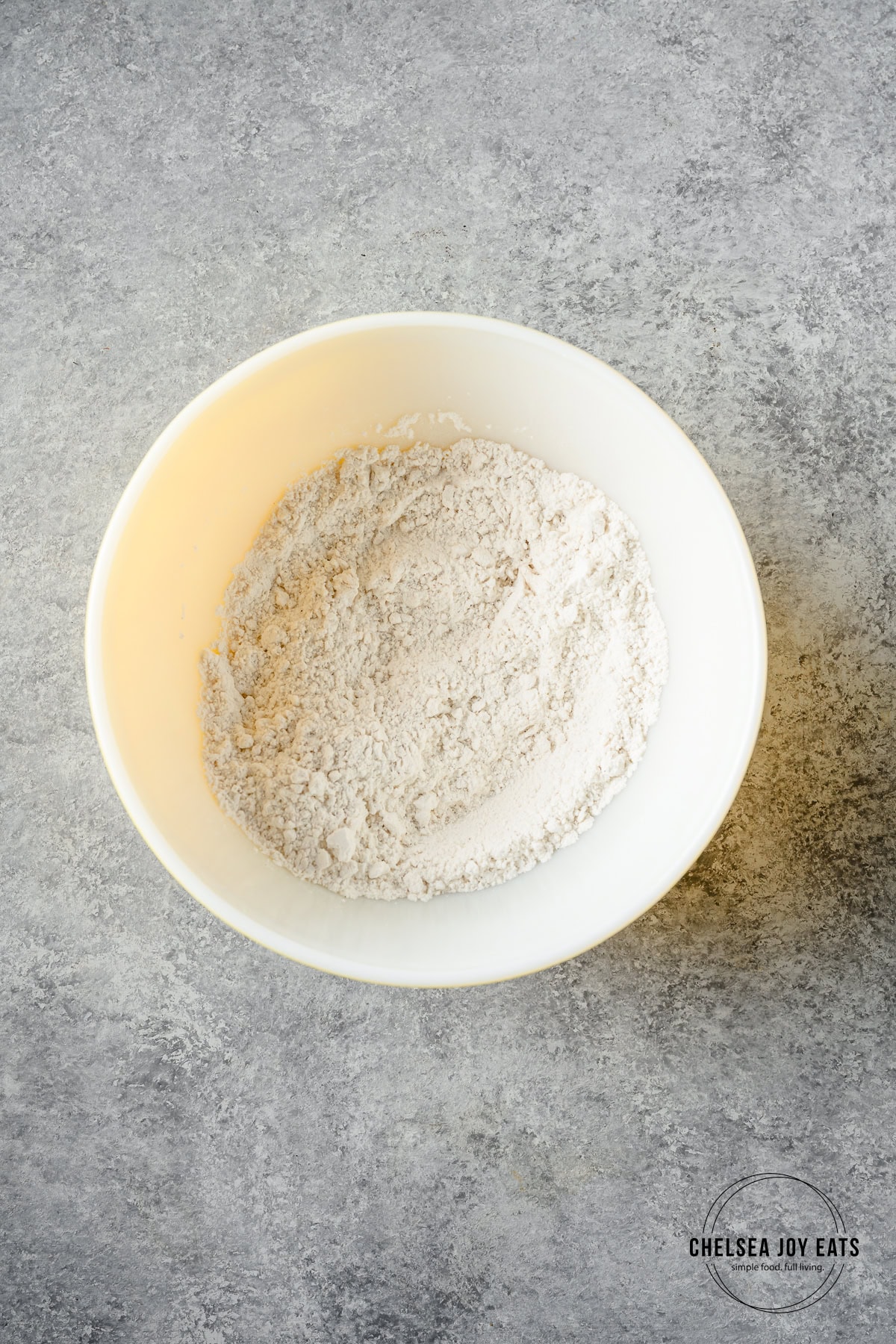 Gluten free flour and baking soda combined in a bowl.