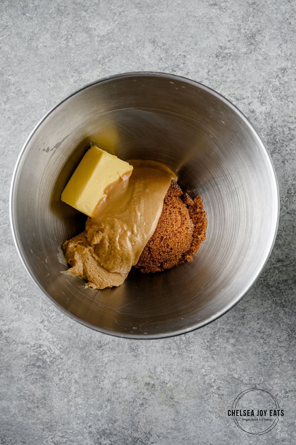 Butter, tahini, and brown sugar in the bowl of a stand mixer.