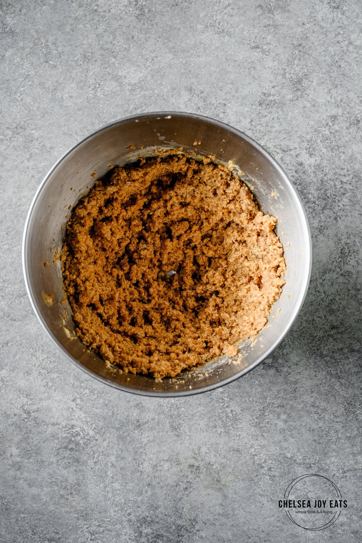 Cookie dough for gluten free tahini cookies in the bowl of a stand mixer.