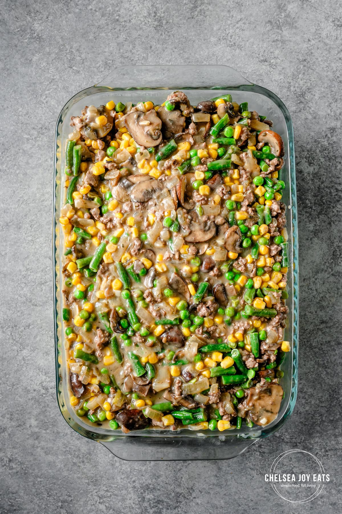 Filling for dairy free tater tot casserole spread out in a 9x13 casserole dish.