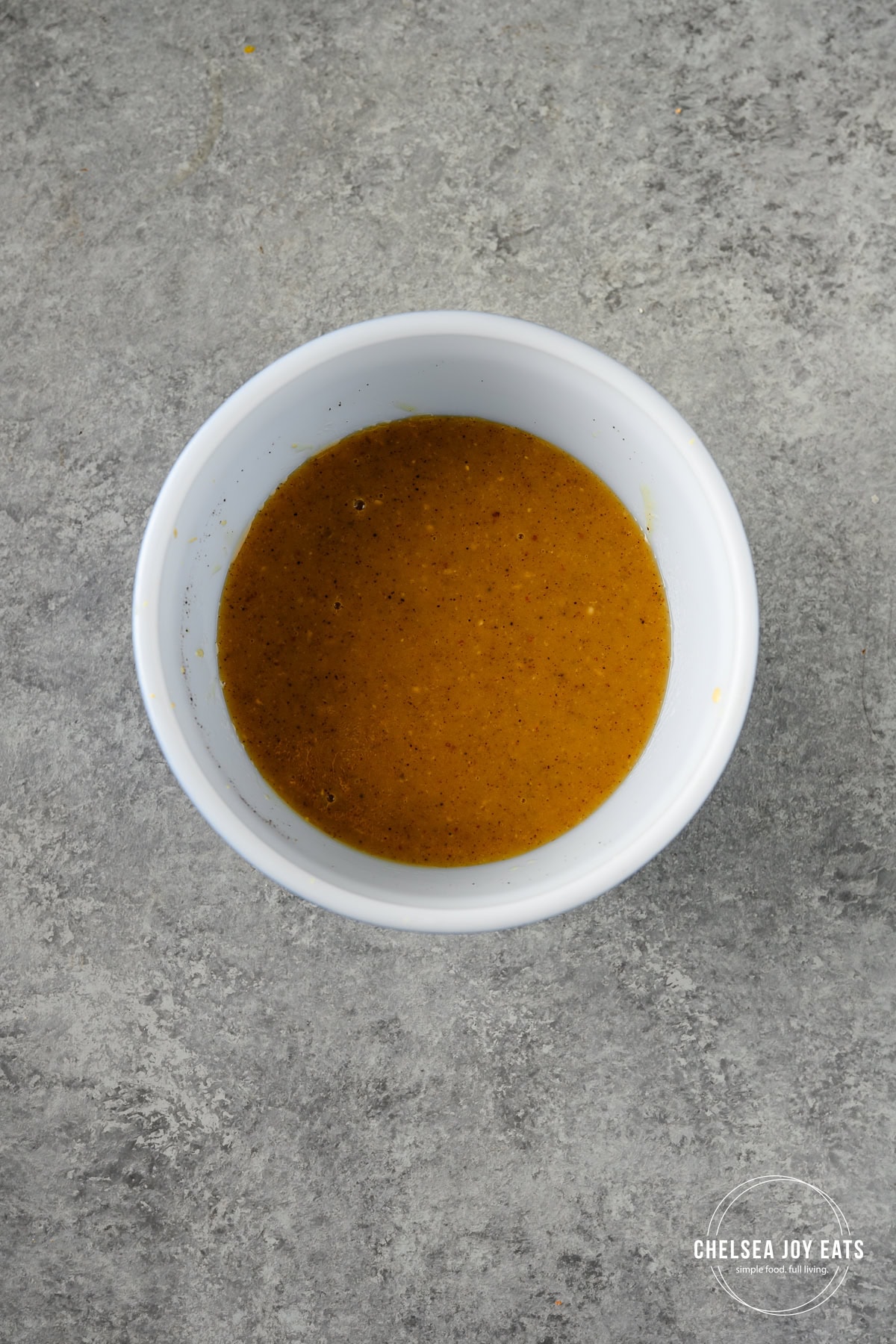 Maple dijon sauce prepared in a small ceramic bow.
